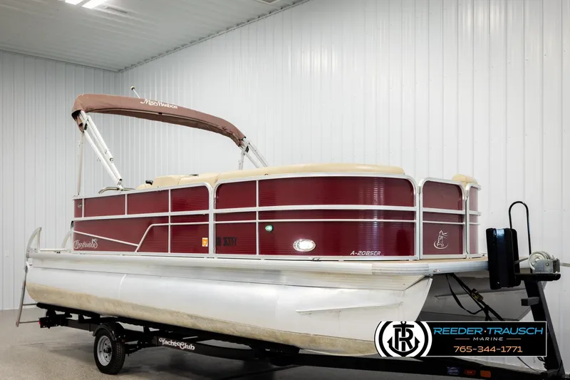 Slide: The Image of 2018 Misty Harbor 2085 CR pontoon boat with maroon exterior on trailer in indoor storage. - 2