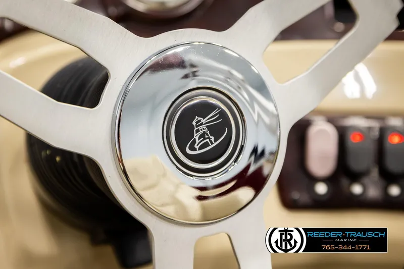 Slide: The Image of Steering wheel of 2018 Misty Harbor 2085 CR boat, featuring a lighthouse emblem. - 31