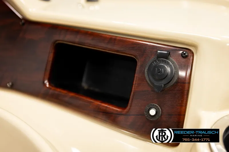 Slide: The Image of 2018 Misty Harbor 2085 CR dashboard with 12V marine outlet and wood finish. - 34