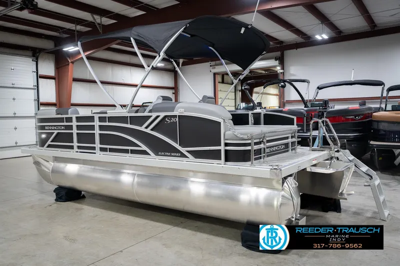 Slide: The Image of 2026 Bennington 20 SSB pontoon boat in showroom, featuring sleek design and modern amenities. - 10
