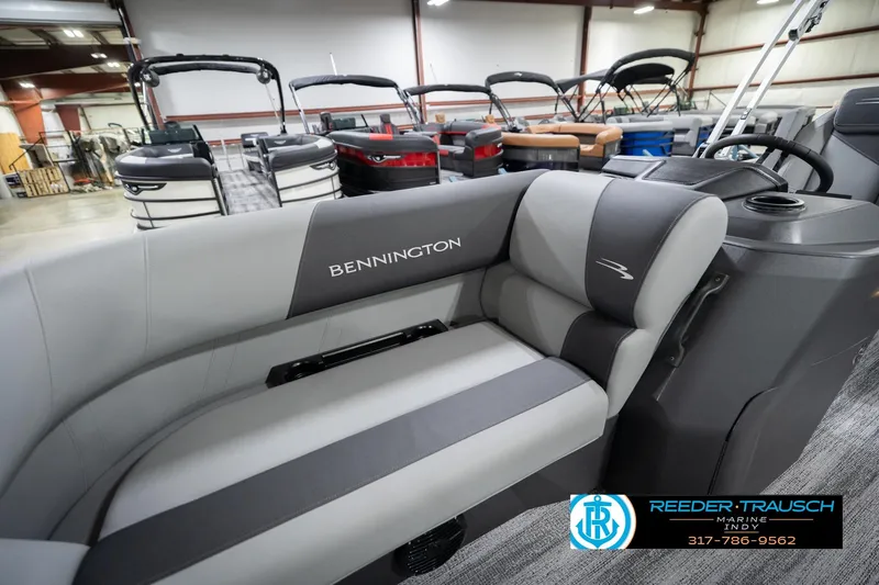 Slide: The Image of 2026 Bennington 20 SSB pontoon boat interior with gray seating in showroom. - 23
