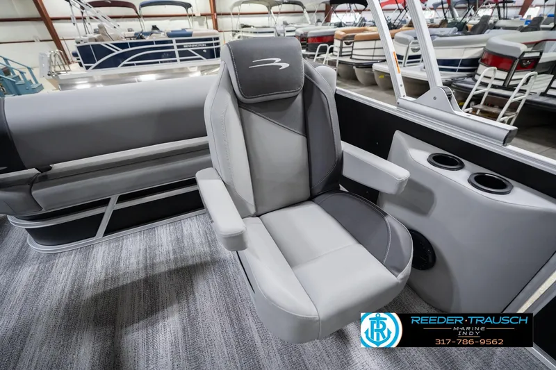 Slide: The Image of 2026 Bennington 20 SSB boat interior with gray captain's chair and cup holders. - 26