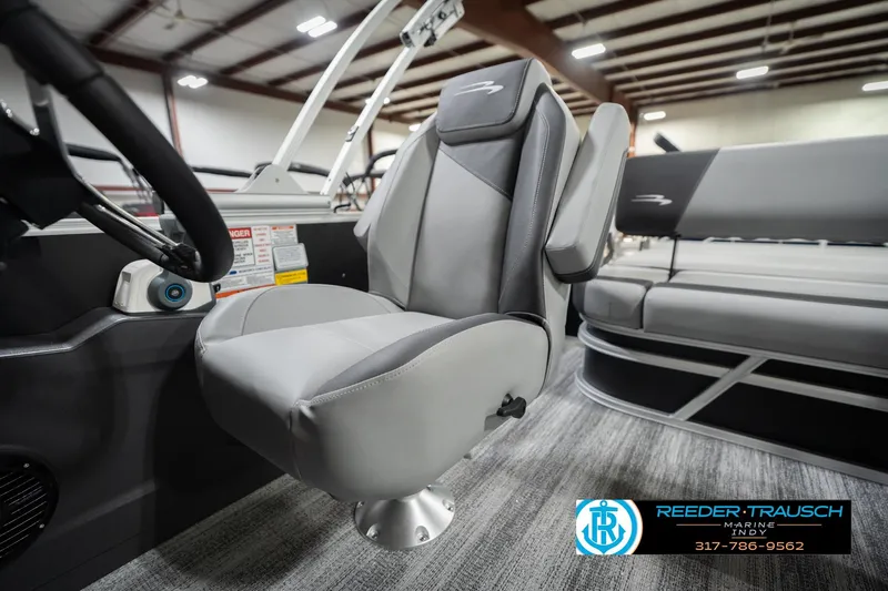 Slide: The Image of 2026 Bennington 20 SSB boat interior with gray captain's chair and steering wheel. - 40