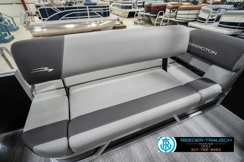 Slide: The Image of 2026 Bennington 20 SSB boat seating in showroom, featuring gray upholstery and sleek design. - 43