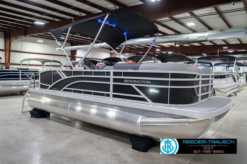Slide: The Image of 2026 Bennington 20 SSB pontoon boat in showroom with canopy and sleek design. - 6