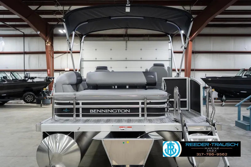 Slide: The Image of 2026 Bennington 20 SSB pontoon boat in showroom, featuring sleek design and modern amenities. - 9