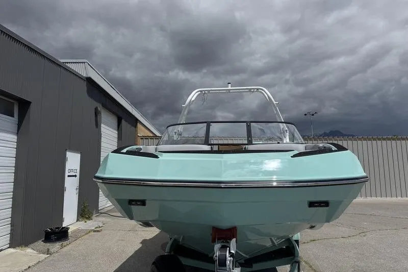 Slide: The Image of 2025 Moomba Max boat in a parking lot under cloudy skies. - 3