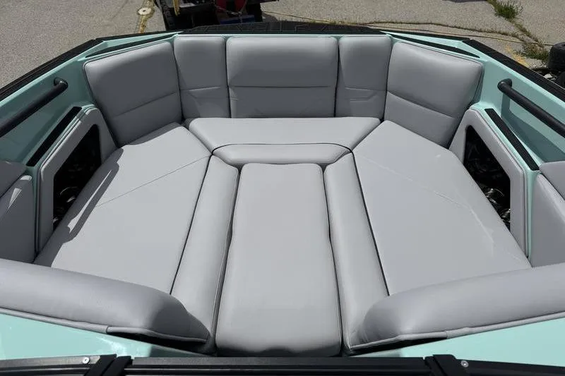 Slide: The Image of 2025 Moomba Max boat interior with spacious, cushioned seating in light gray upholstery. - 4