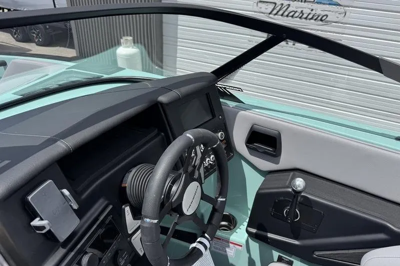 Slide: The Image of 2025 Moomba Max boat interior with steering wheel and dashboard controls. - 6