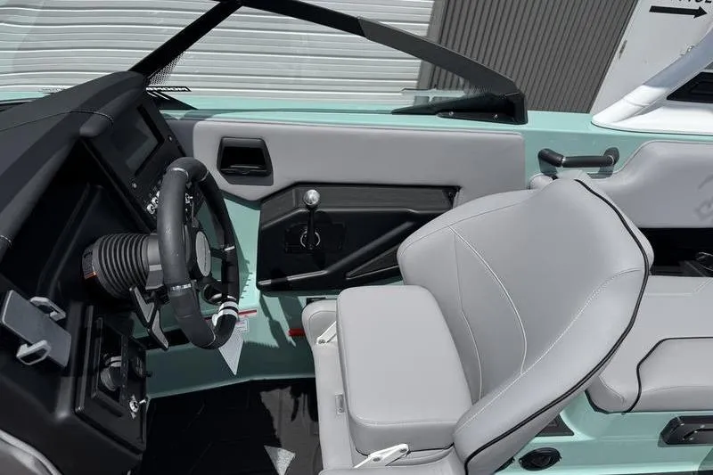Slide: The Image of 2025 Moomba Max boat interior with modern steering and gray seating. - 8