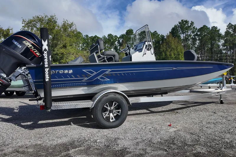 The Image of 2026 Xpress H20B Bay boat with Yamaha engine on trailer, parked outdoors. - 0