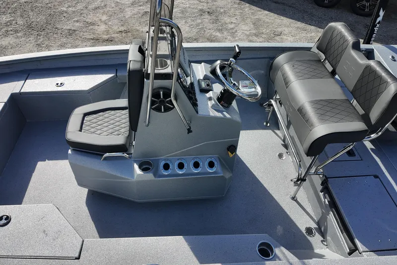 Slide: The Image of 2026 Xpress H20B Bay boat interior with modern seating and steering console. - 11