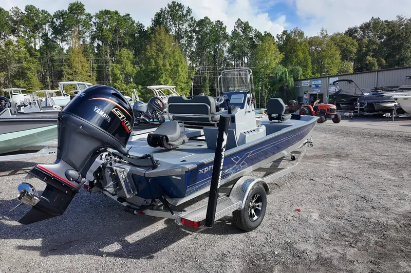 Slide: The Image of 2026 Xpress H20B Bay boat with Yamaha engine on a trailer, parked outdoors. - 3