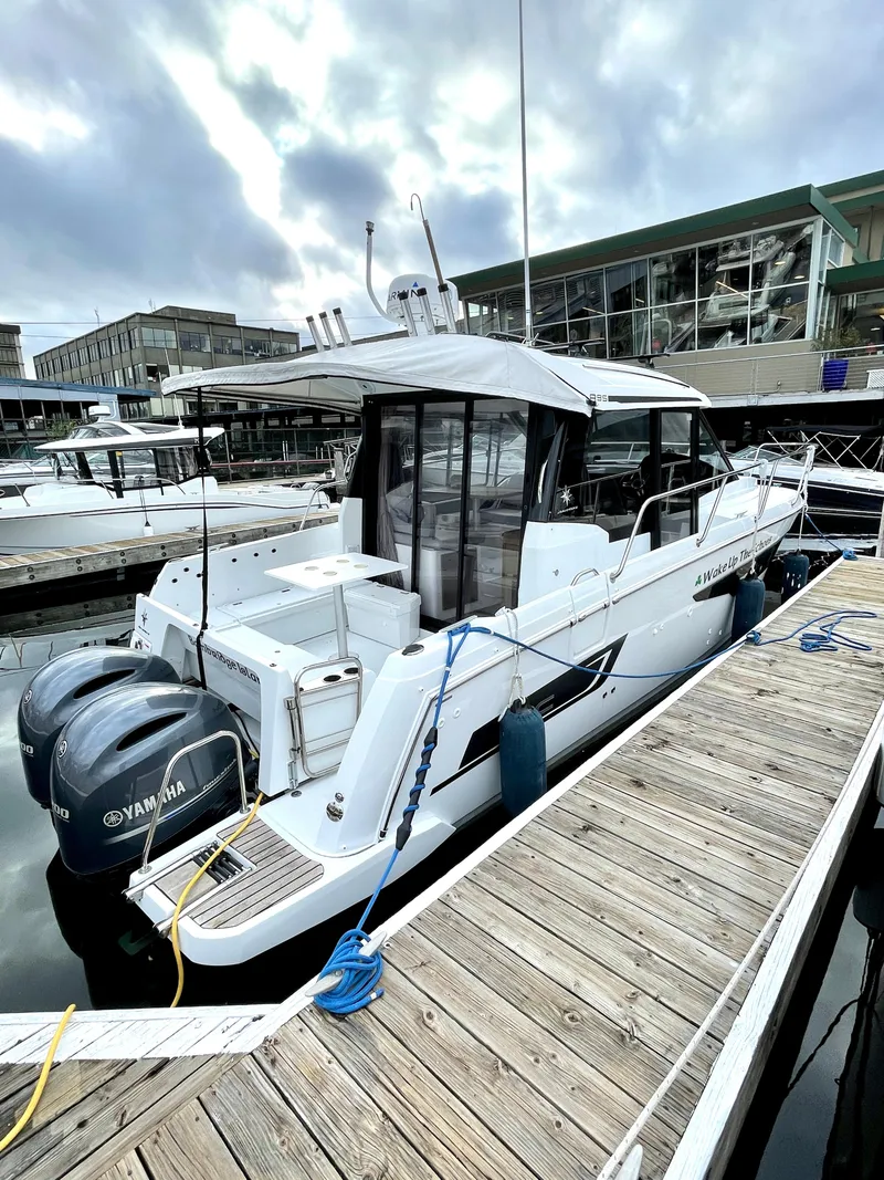 The Image of 2019 Jeanneau NC 895 boat docked with Yamaha engines, cloudy sky background. - 0