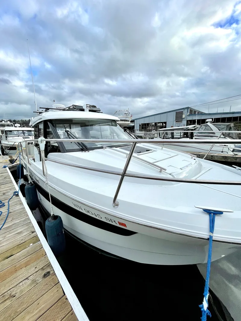 Slide: The Image of 2019 Jeanneau NC 895 boat docked at marina under cloudy sky. - 15