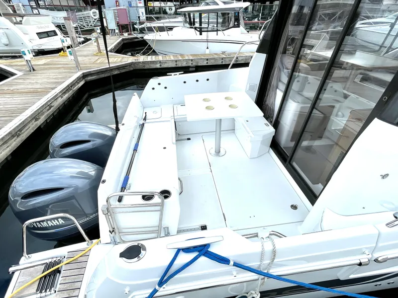 Slide: The Image of 2019 Jeanneau NC 895 boat with Yamaha engines docked at marina. - 2