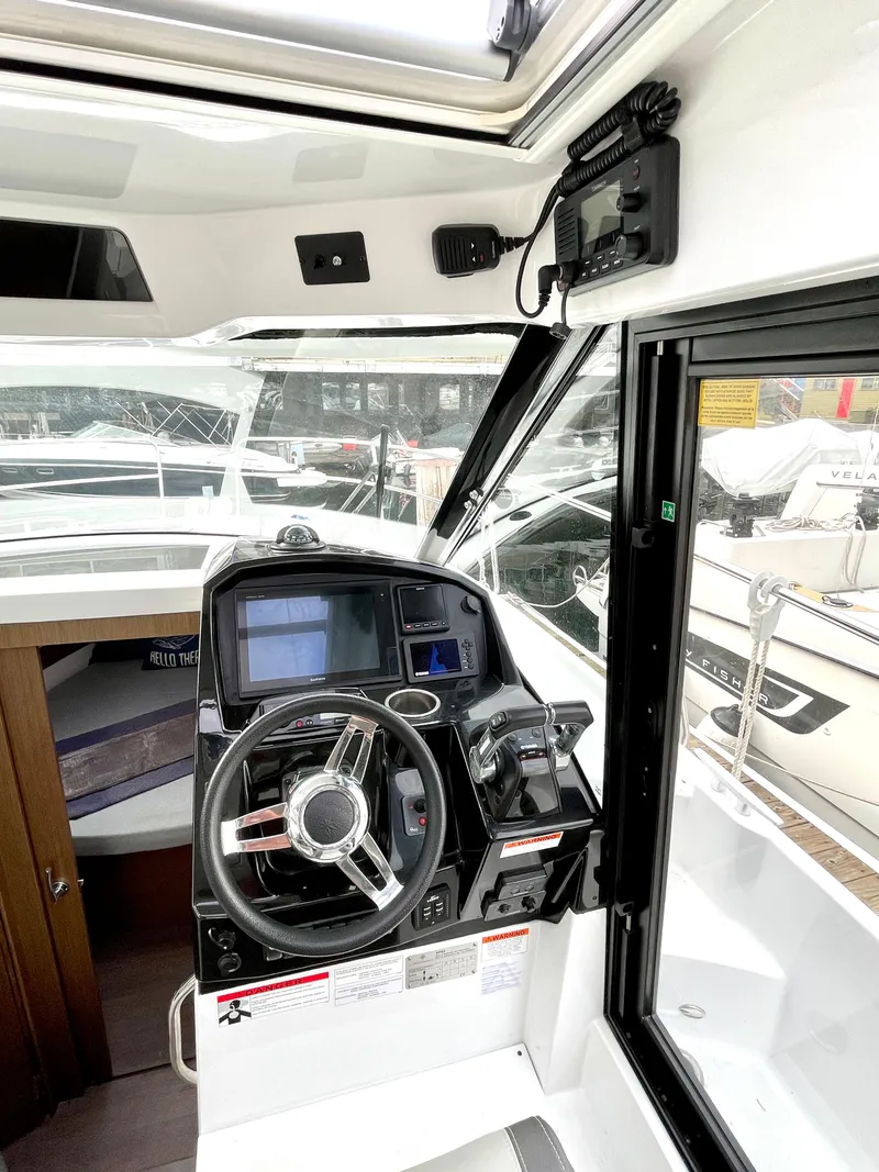 Slide: The Image of 2019 Jeanneau NC 895 helm with modern navigation equipment and steering wheel. - 5