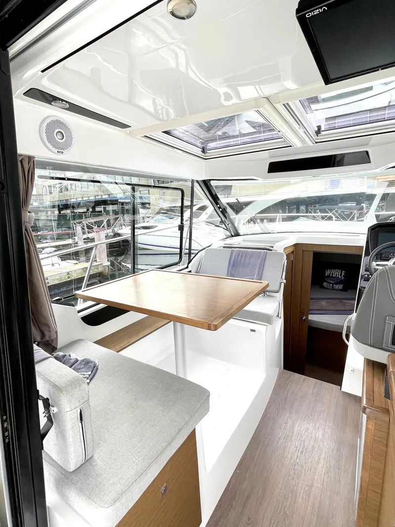 Slide: The Image of Interior of 2019 Jeanneau NC 895 boat with modern seating and table. - 7