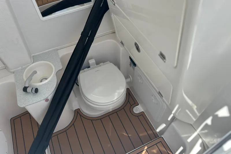 Slide: The Image of 2026 Sea Fox 268 Commander boat bathroom with toilet, sink, and wooden flooring. - 14