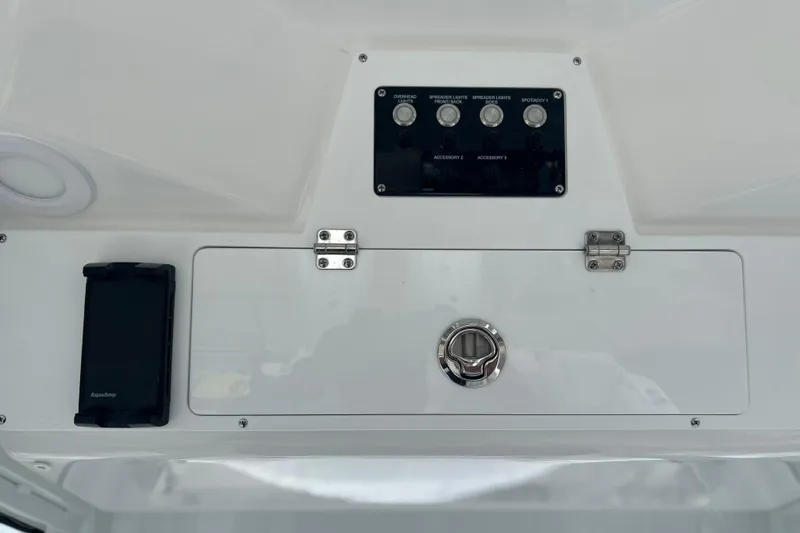 Slide: The Image of Control panel of 2026 Sea Fox 268 Commander boat with switches and storage compartment. - 24