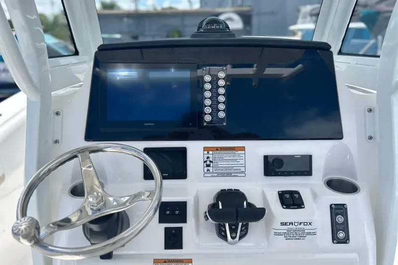 Slide: The Image of 2026 Sea Fox 268 Commander helm with steering wheel and navigation display. - 3