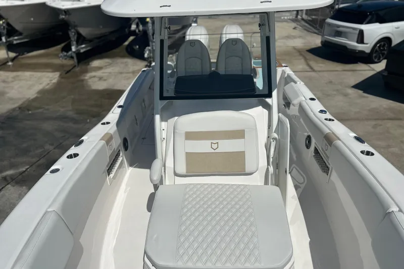 Slide: The Image of 2026 Sea Fox 268 Commander boat interior with seating and console, docked outdoors. - 41
