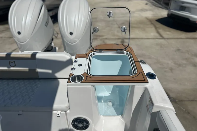 Slide: The Image of 2026 Sea Fox 268 Commander boat with open livewell and dual outboard engines. - 42