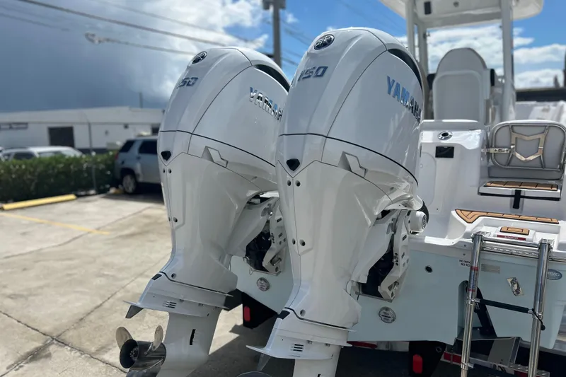 Slide: The Image of 2026 Sea Fox 268 Commander with twin Yamaha 150 outboard engines in a parking lot. - 45