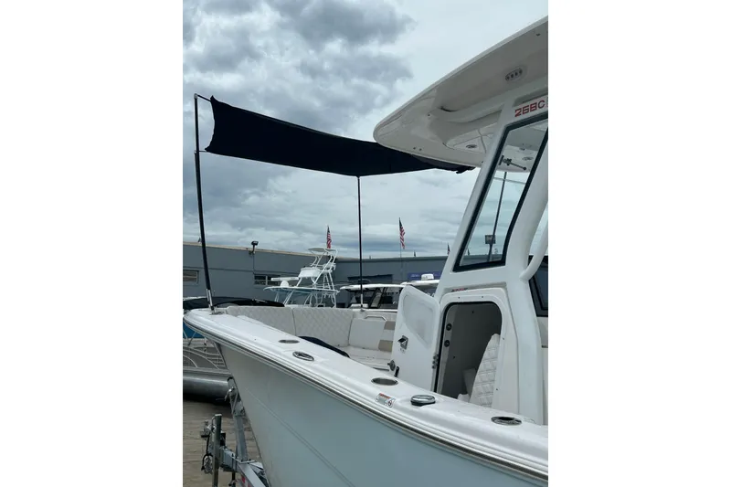 Slide: The Image of 2026 Sea Fox 268 Commander boat with canopy, docked under cloudy skies. - 58