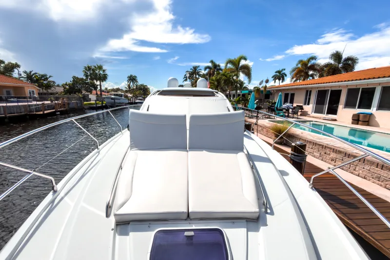 Slide: The Image of 2015 Beneteau Gran Turismo 49 yacht docked by waterfront homes, sunny day. - 16