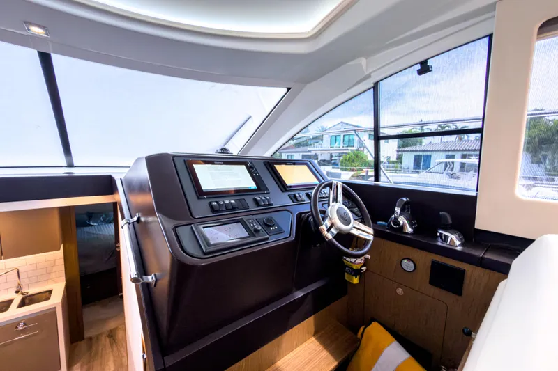 Slide: The Image of Helm station of 2015 Beneteau Gran Turismo 49 yacht, featuring modern controls and navigation systems. - 22