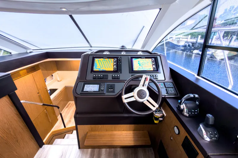 Slide: The Image of 2015 Beneteau Gran Turismo 49 yacht helm with modern navigation systems and luxurious interior. - 23