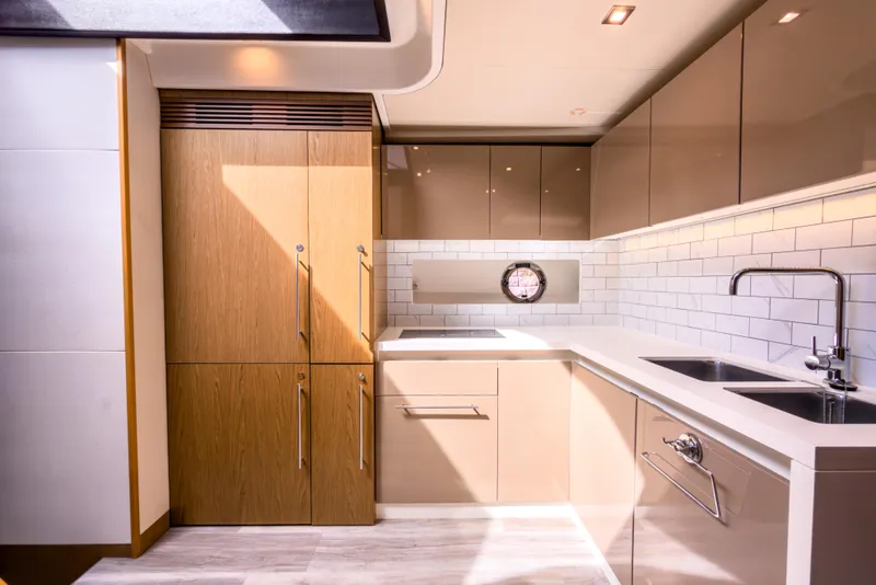 Slide: The Image of Luxurious kitchen interior of 2015 Beneteau Gran Turismo 49 yacht, featuring modern cabinetry and fixtures. - 25