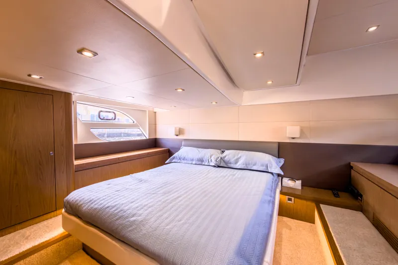 Slide: The Image of Luxurious bedroom interior of 2015 Beneteau Gran Turismo 49 yacht, featuring elegant design and cozy ambiance. - 28
