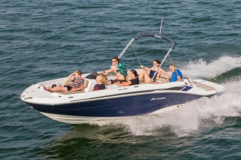 The Image of 2021 Hurricane SunDeck Sport 205 IO boat, white and blue, docked outdoors. - 0