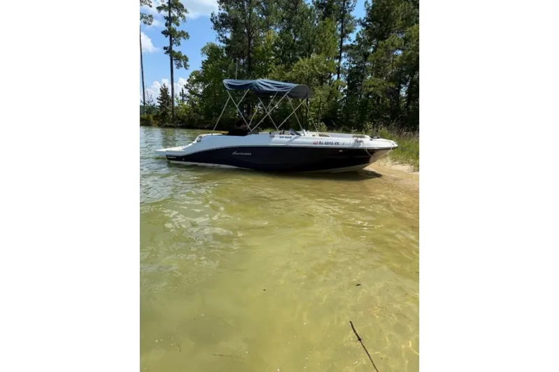 Slide: The Image of 2021 Hurricane SunDeck Sport 205 IO boat interior with beige seating and speakers. - 13