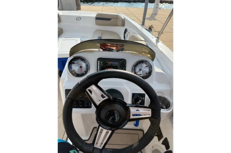Slide: The Image of 2021 Hurricane SunDeck Sport 205 IO boat interior with beige seating and speaker. - 14
