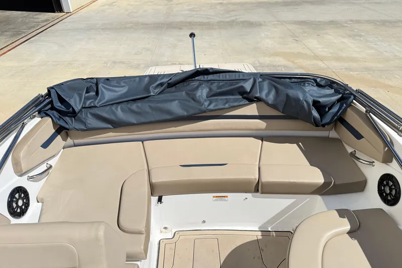 Slide: The Image of 2021 Hurricane SunDeck Sport 205 IO boat interior with beige seating and folded canopy. - 16