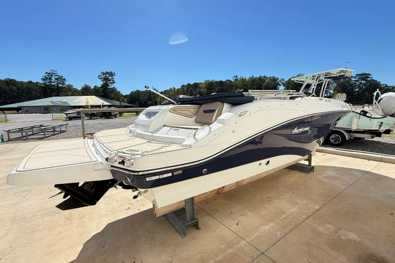 Slide: The Image of 2021 Hurricane SunDeck Sport 205 IO boat on display, outdoor setting, clear blue sky. - 3