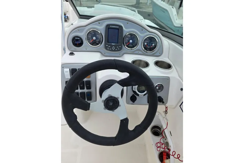 Slide: The Image of 2012 Hurricane SunDeck 2000 OB boat dashboard with steering wheel and gauges. - 10