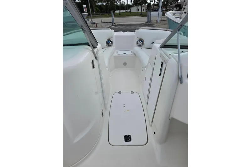 Slide: The Image of 2012 Hurricane SunDeck 2000 OB boat interior, featuring white seating and storage compartments. - 12