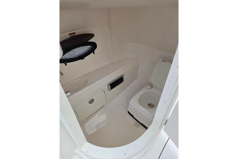 Slide: The Image of Interior of 2012 Hurricane SunDeck 2000 OB boat with compact marine toilet. - 13