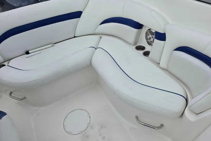 Slide: The Image of 2012 Hurricane SunDeck 2000 OB boat interior with white and blue seating. - 14