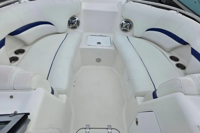 Slide: The Image of 2012 Hurricane SunDeck 2000 OB boat interior with white seating and cup holders. - 15