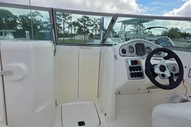 Slide: The Image of 2012 Hurricane SunDeck 2000 OB boat cockpit with steering wheel and control panel. - 18