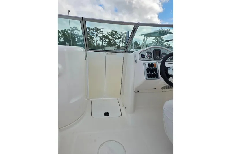 Slide: The Image of 2012 Hurricane SunDeck 2000 OB boat interior with steering console and windshield. - 19
