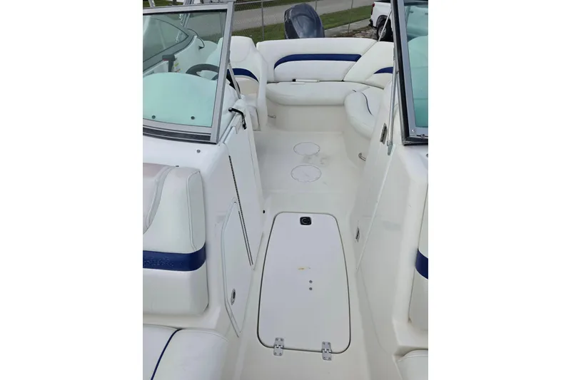 Slide: The Image of 2012 Hurricane SunDeck 2000 OB interior with white seating and blue accents. - 22