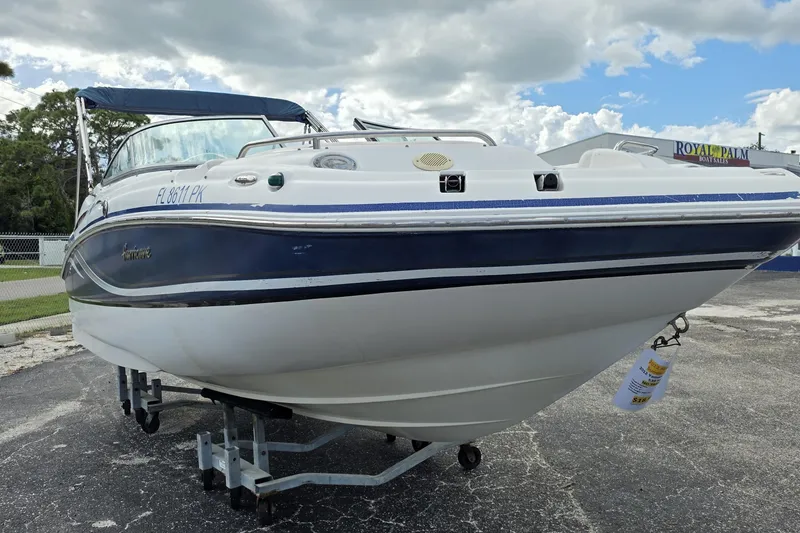 Slide: The Image of 2012 Hurricane SunDeck 2000 OB boat on trailer under cloudy sky. - 3
