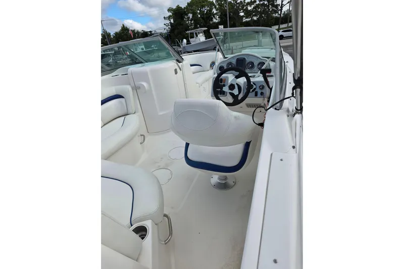 Slide: The Image of 2012 Hurricane SunDeck 2000 OB boat interior with white seating and steering console. - 9