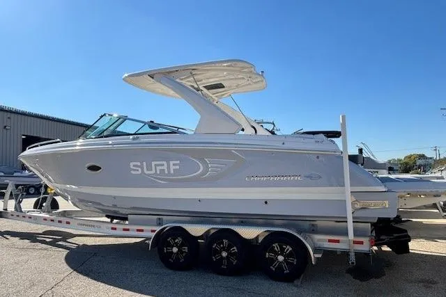 Slide: The Image of 2024 Chaparral 30 Surf boat on trailer under clear blue sky. - 11